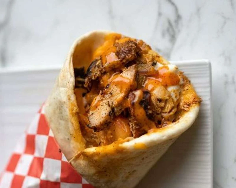 Poyos piri piri chicken wrap packed for grab and go takeout near King Street London Ontario